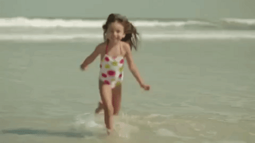 Cute Girl Running At The Beach